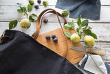 Millie Lottie Etta Food & Picnic Tote, Large, Black Canvas on Table with removable cutting board surrounded by pears